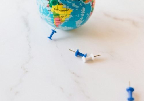 pexels-photo-7236027-7236027 A small globe adorned with colorful pins, symbolizing travel and world exploration.
